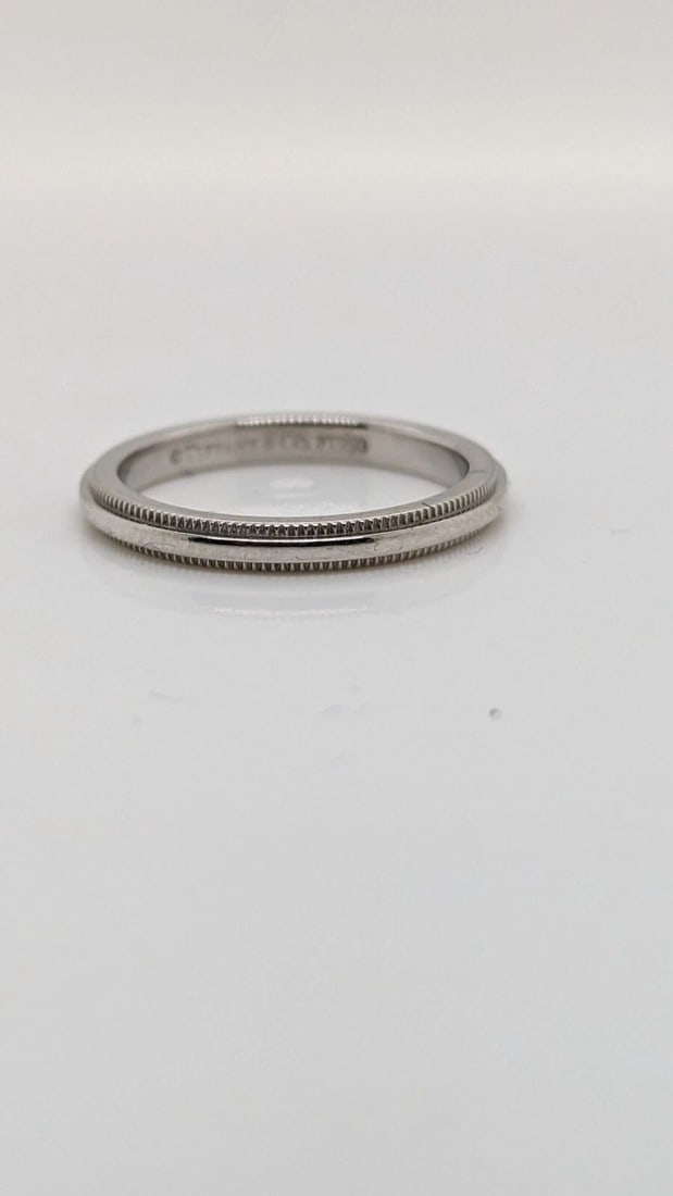 TIFFANY & CO. TOGETHER PLATINUM 2.2MM MILGRAIN WEDDING BAND RING SIZE 4.5: Tiffany & Co. Tiffany Together Platinum Milgrain Wedding Band Ring Ring Size - 4.5 Width - 2.2mm Weight - 3.5 Grams Professionally polished & Looks like New Pouch Not Included
