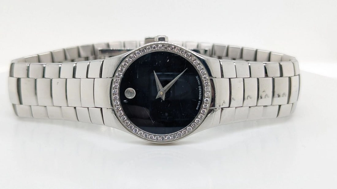 MOVADO STRATO 84 A1 2847 S BLACK DIAL DIAMOND BEZEL LADIES QUARTZ WATCH - 26 MM: MOVADO STRATO 84 A1 2847 S BLACK DIAL DIAMOND BEZEL LADIES QUARTZ WATCH - 26 MM Movado Strato Black Dial Diamond Bezel Women's Watch Reference - 84 A1 2847 S Case Size - 26mm Bracelet Fits up to a 7.2