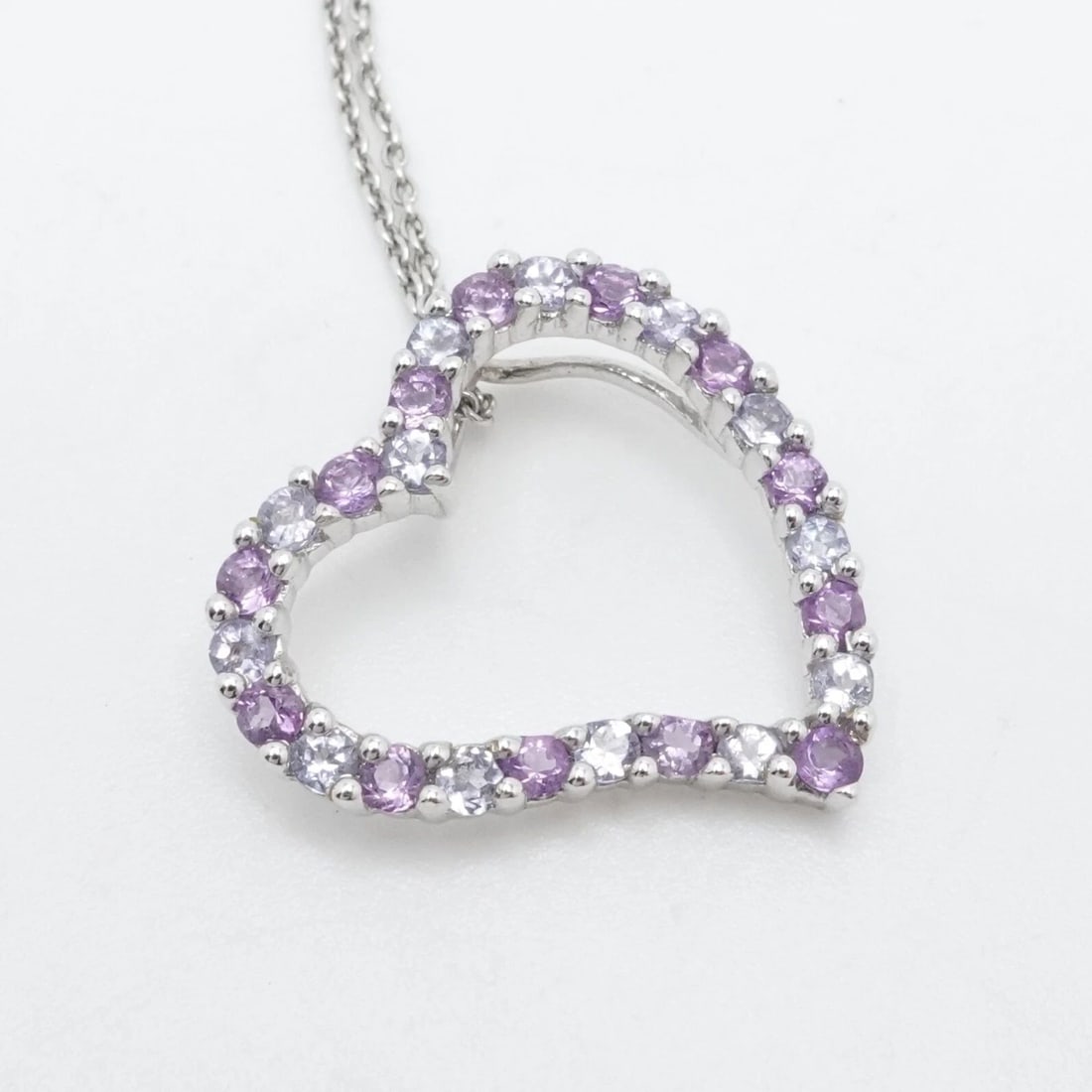 B.H 14K WHITE GOLD AMETHYST & TANZANITE OPEN HEART PENDANT NECKLACE 16" RECEIPT: B.H 14K WHITE GOLD AMETHYST & TANZANITE OPEN HEART PENDANT NECKLACE 16" RECEIPT Signed B.H 14K White Gold Amethyst and Tanzanite Heart Pendant Chain Necklace Length - 16" Long Chain Width - 1mm Pendan