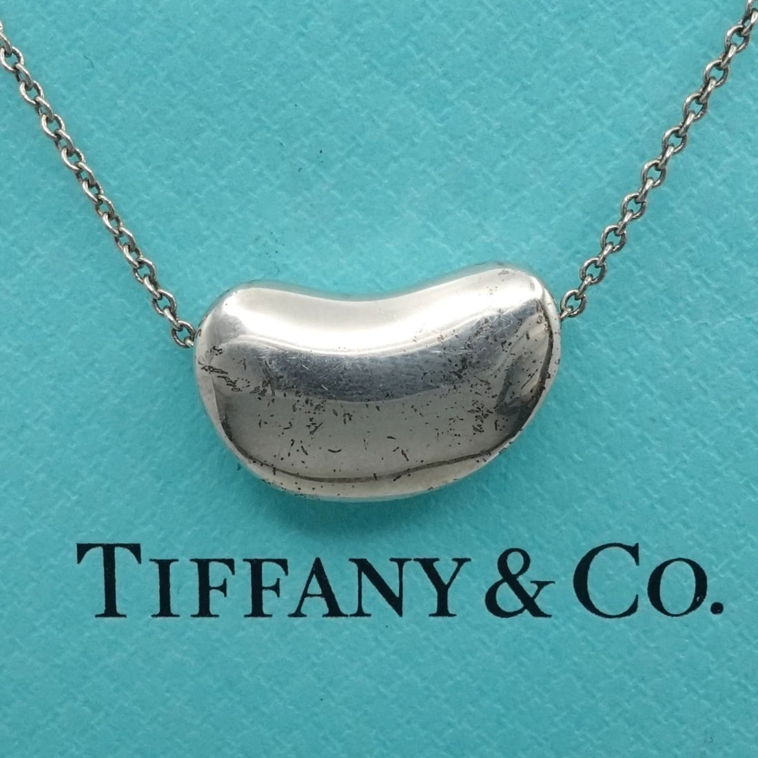 TIFFANY & CO. PERETTI STERLING SILVER 20MM BEAN PENDANT NECKLACE 18": TIFFANY & CO. PERETTI STERLING SILVER 20MM BEAN PENDANT NECKLACE 18" Tiffany & Co. Elsa Peretti Sterling Silver 20mm Bean Pendant Necklace Length - 18" Chain Width - 1mm Pendant Size (LxW) - 13mm x 20