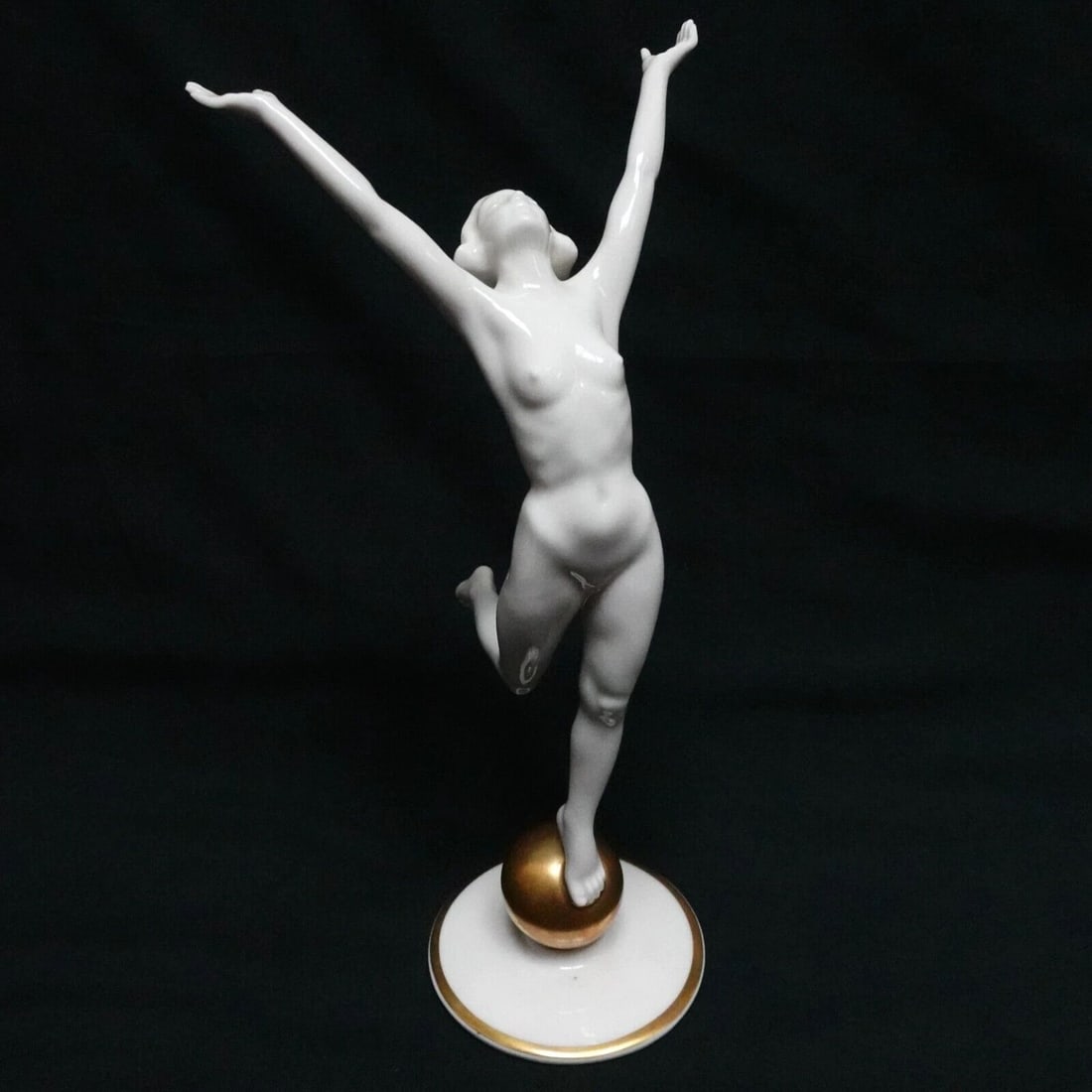 HUTSCHENREUTHER NUDE WOMAN STANDING ON GOLD BALL PORCELAIN FIGURINE - 8.5" TALL: HUTSCHENREUTHER NUDE WOMAN STANDING ON GOLD BALL PORCELAIN FIGURINE - 8.5" TALL Hutschenreuther Kunstabteilung Germany Nude Woman Standing On Gold Ball Art Deco Style Porcelain Figurine by Artist Karl