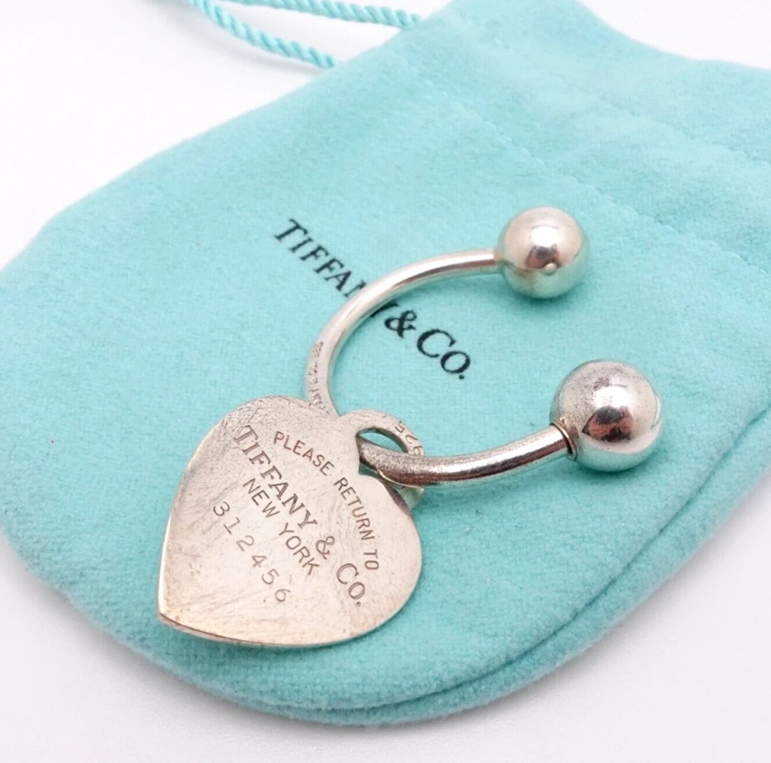 TIFFANY & CO. RETURN TO STERLING SILVER KEY CHAIN HEART TAG CHARM: Tiffany & Co. Sterling Silver Return To Tiffany Heart Tag Screwball Key Tag Height - 1" in. approx. Tag Width - 3/4" in. approx. Est. Retail 250 Pouch NOT Included