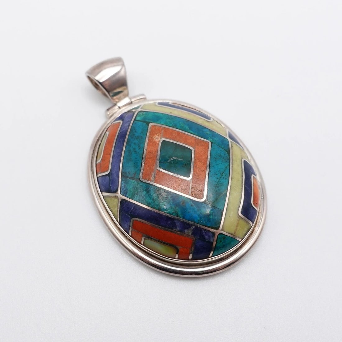 SILVER 950 PERU MULTI GEMSTONE INLAY OVAL PENDANT - 2.25": SILVER 950 PERU MULTI GEMSTONE INLAY OVAL PENDANT - 2.25" Silver 950 Peru Multi Gemstone Inlay Oval Pendant Height - 2.25" Length - 1.40" Bail Height - 8mm Bail Width - 6.5mm Total Weight - 32 Grams