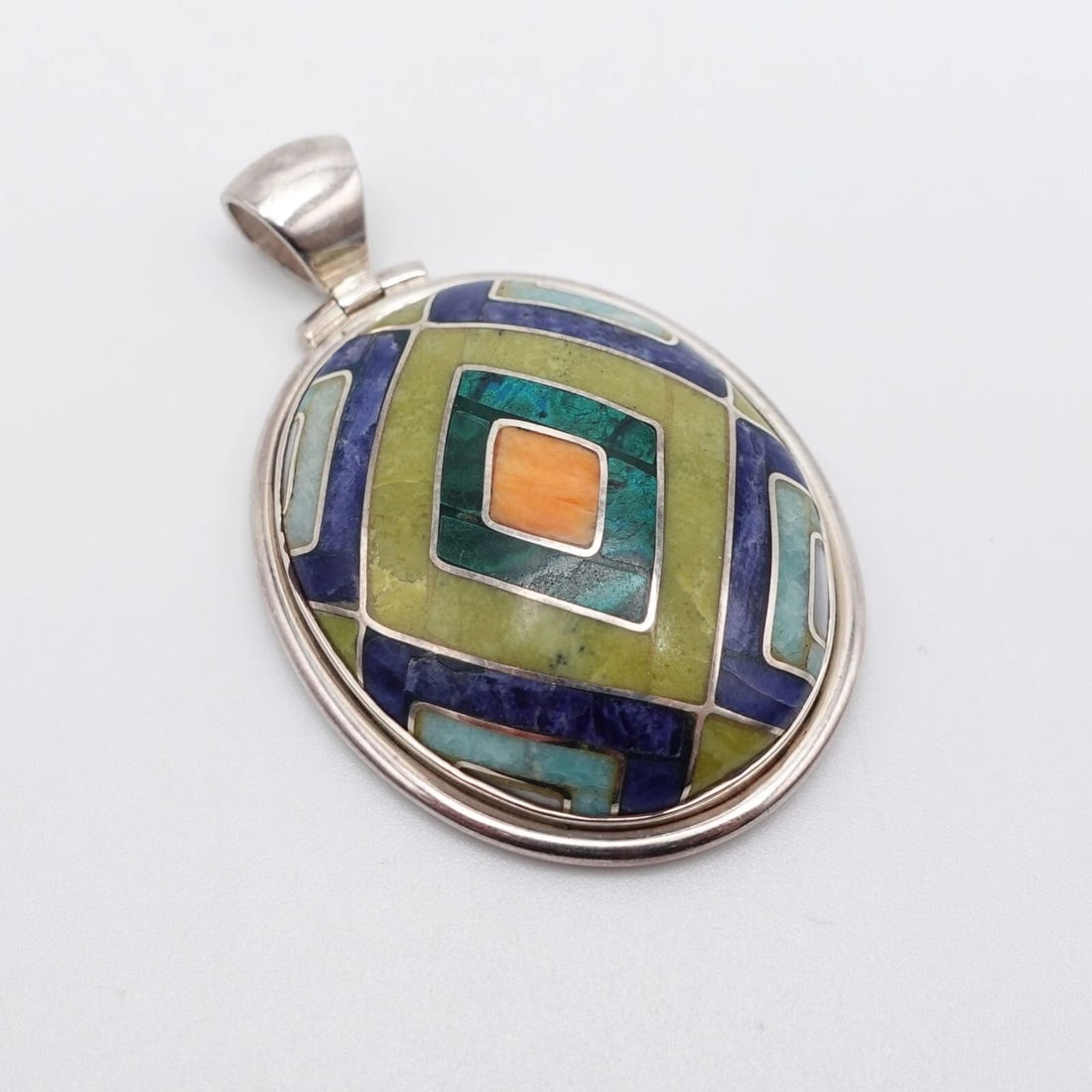 SILVER 950 PERU MULTI GEMSTONE INLAY OVAL PENDANT - 2.25": SILVER 950 PERU MULTI GEMSTONE INLAY OVAL PENDANT - 2.25" Silver 950 Peru Multi Gemstone Inlay Oval Pendant Height - 2.25" Length - 1.40" Bail Height - 8mm Bail Width - 6.5mm Total Weight - 32.3 Grams