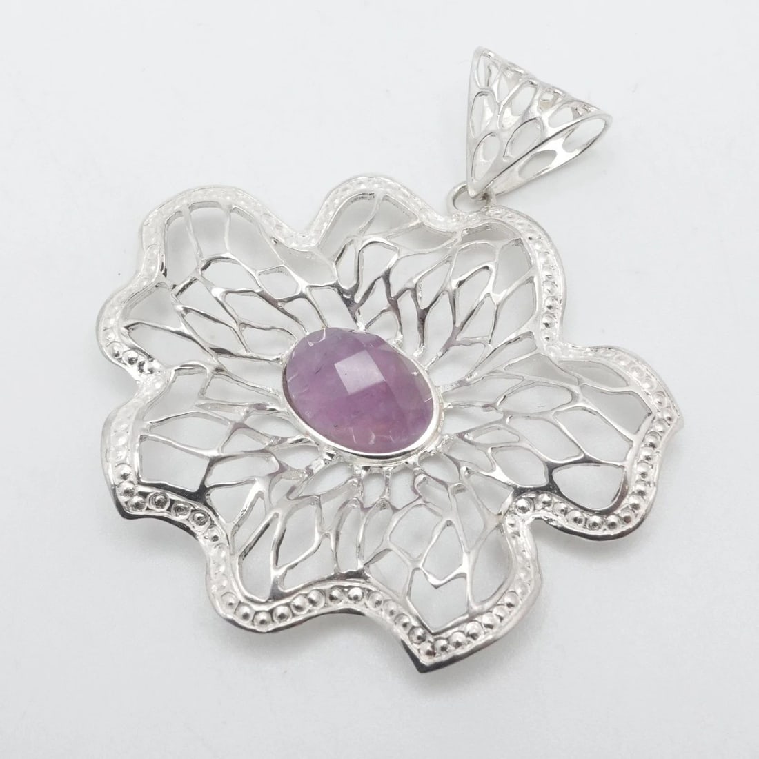 RIDER SILVER 950 OPENWORK FLOWER FACETED AMETHYST PENDANT 2.5": RIDER SILVER 950 OPENWORK FLOWER FACETED AMETHYST PENDANT 2.5" Rider Silver 950 Openwork Flower Faceted Amethyst Pendant Length - 2.5" Width - 2.1" Bail Size (HxW) - 12mm x 6mm Gemstone Size - 14 x 10