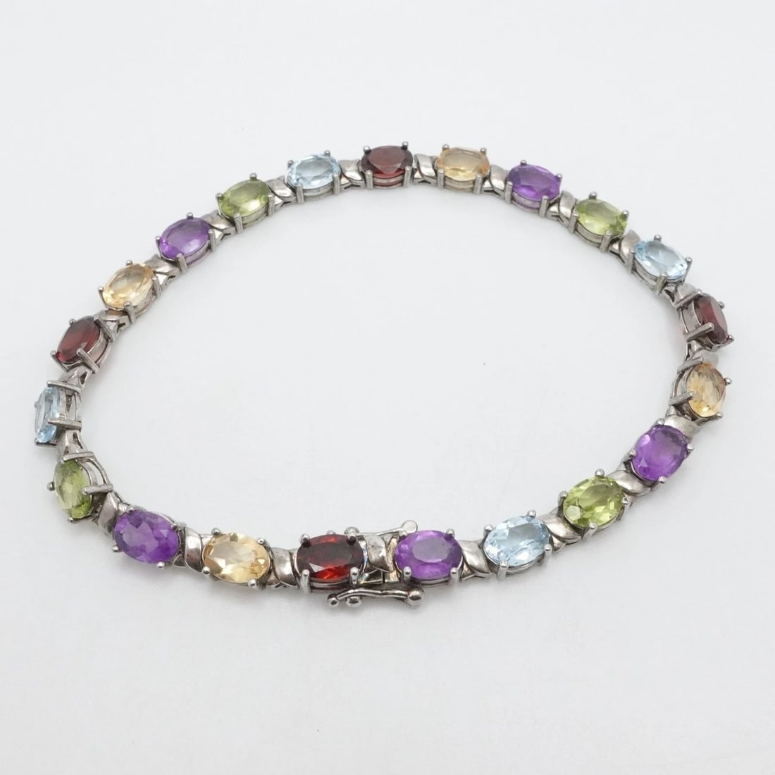 BBJ STERLING SILVER OVAL FACETED MULTI GEMSTONE TENNIS BRACELET 8.25" LONG: BBJ STERLING SILVER OVAL FACETED MULTI GEMSTONE TENNIS BRACELET 8.25" LONG Signed BBJ Sterling Silver Oval Faceted Multi Gemstone Tennis Bracelet Length - 8.25" Long Wrist Size - 8" Chain Width - 5.5m