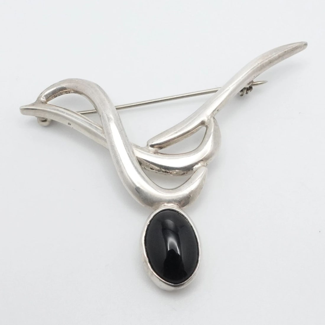 TAXCO STERLING SILVER MEXICO OVAL BLACK ONYX MODERNIST BROOCH PIN: TAXCO STERLING SILVER MEXICO OVAL BLACK ONYX MODERNIST BROOCH PIN Taxco Sterling Silver Mexico Oval Black Onyx Modernist Brooch Pin Size (LxW) - 2.5" x 1.7" Gemstone Size - 14.5mm x 11mm Total Weight 