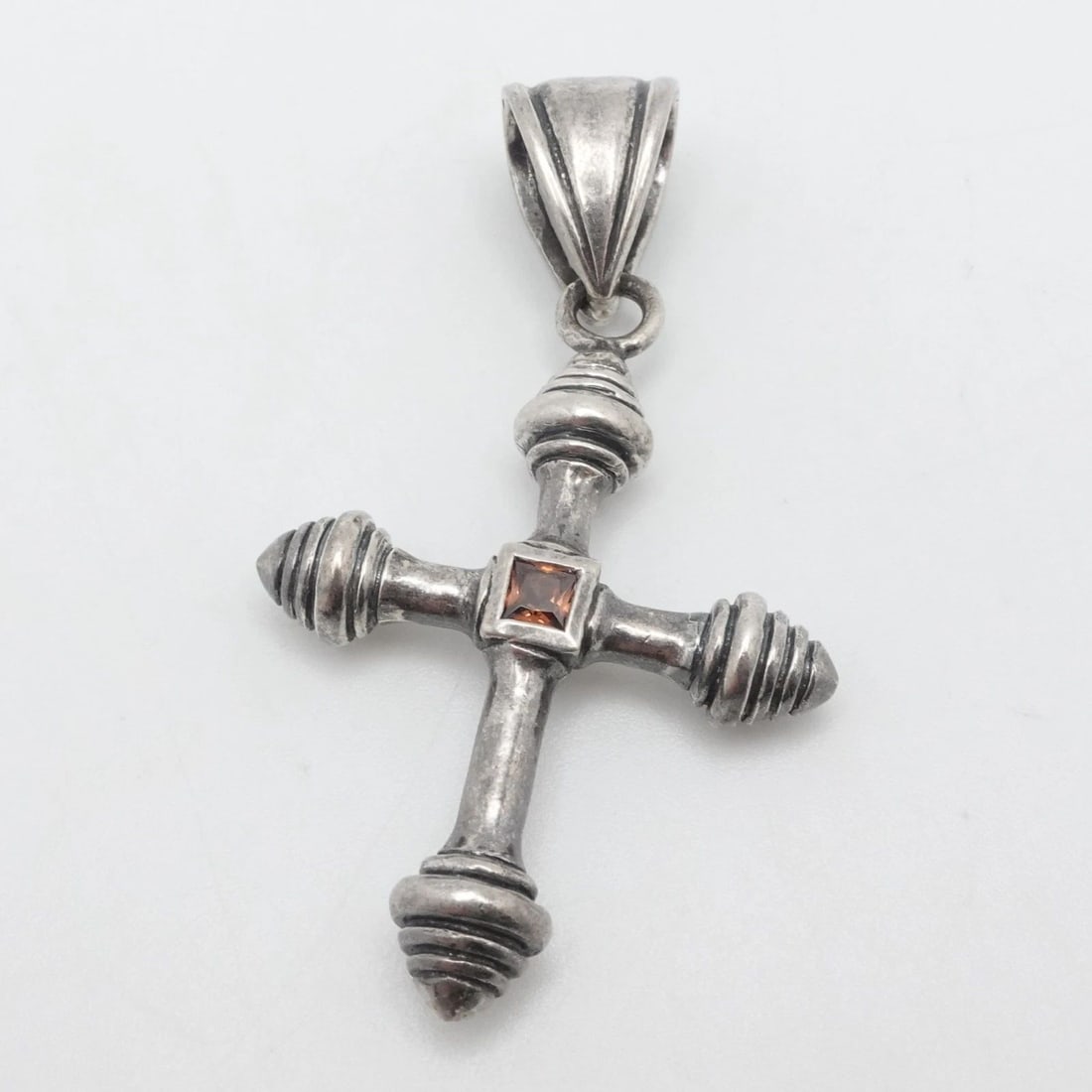 STERLING SILVER ORANGE GARNET CROSS PENDANT 2.5": STERLING SILVER ORANGE GARNET CROSS PENDANT 2.5" Sterling Silver Orange Garnet Cross Pendant Total Length - 2.5" Bail Size (HxW) - 12mm x 8mm Gemstone Size - 4mm Total Weight - 17.5 Grams