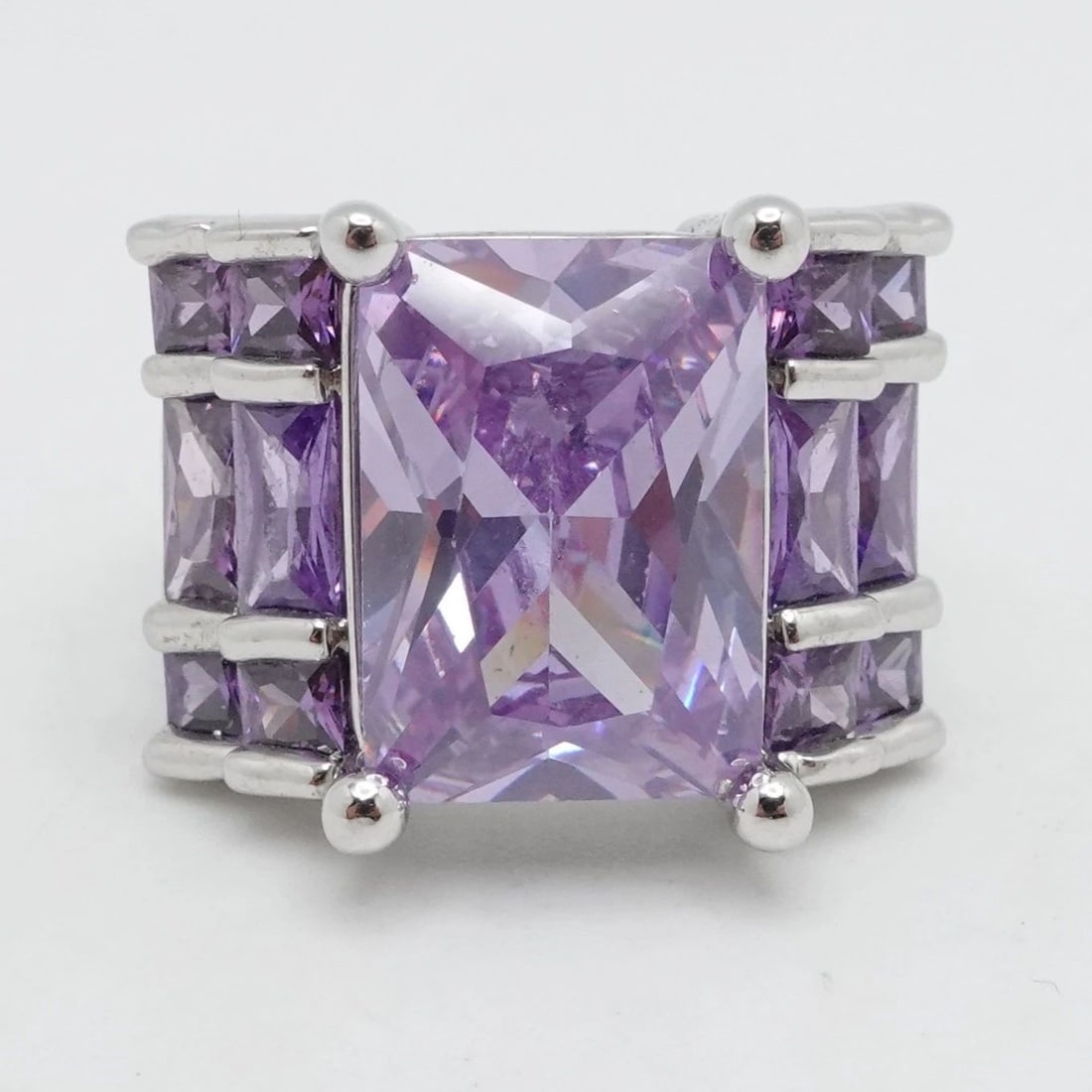 STERLING SILVER PURPLE AMETHYST EMERALD CUT COCKTAIL RING SIZE 7.25: STERLING SILVER PURPLE AMETHYST EMERALD CUT COCKTAIL RING SIZE 7.25 Sterling Silver Purple Amethyst Emerald Cut Cocktail Ring Size - 7.25 Band Width - 6mm Height - 15mm Total Weight - 12 Grams