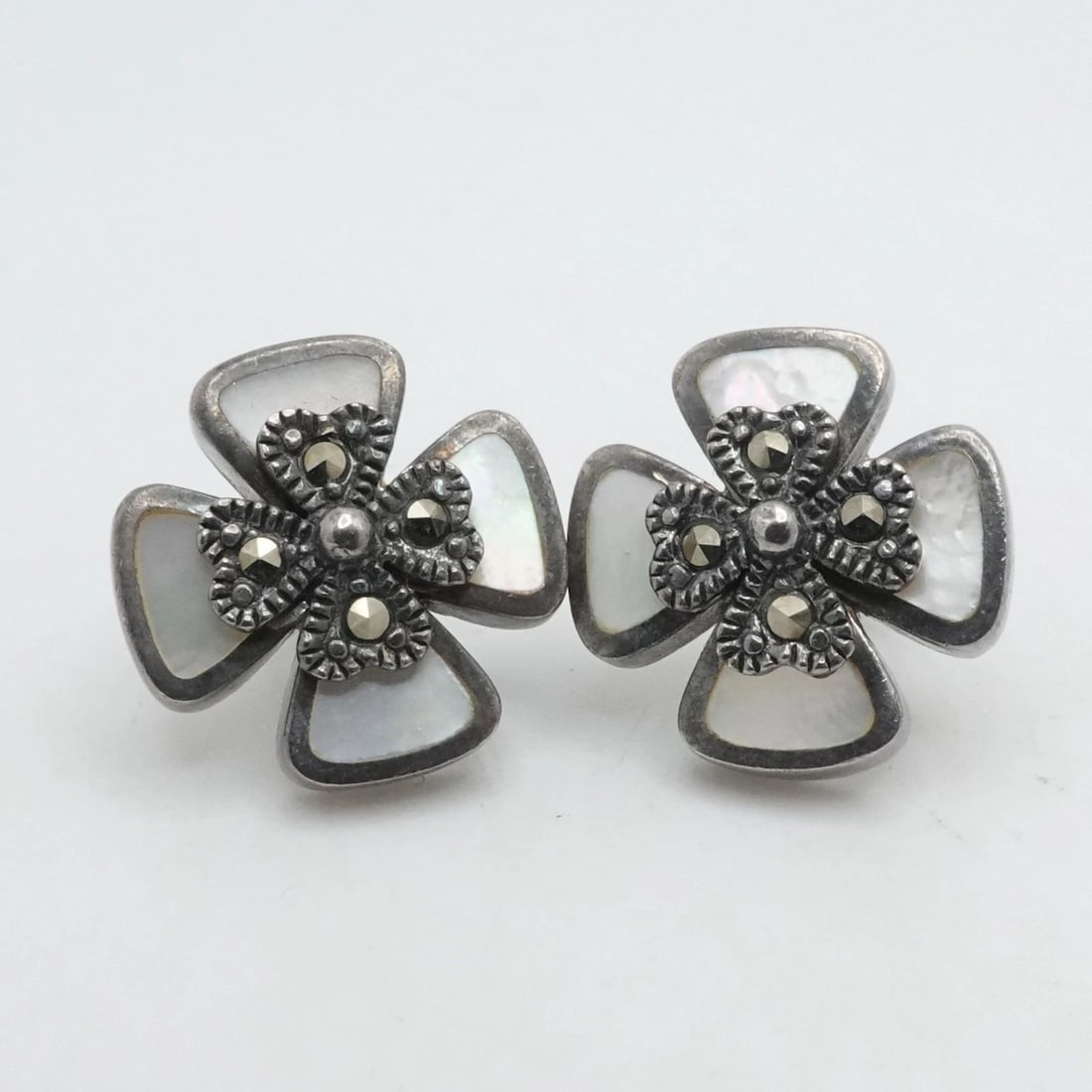 STERLING SILVER MOTHER OF PEARL INLAY MARCASITE CROSS STUD EARRINGS: STERLING SILVER MOTHER OF PEARL INLAY MARCASITE CROSS STUD EARRINGS Sterling Silver Mother of Pearl Inlay & Marcasite Cross Stud Earrings Length - 0.60 Thickness - 4mm Total Weight - 6Grams