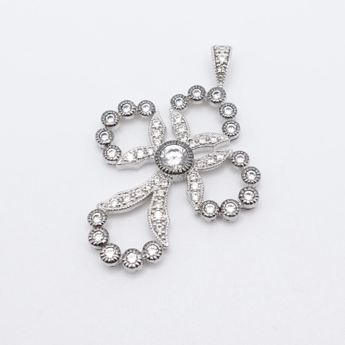 ADI STERLING SILVER ROUND CLEAR CZ CUBIC ZIRCONIA CROSS PENDANT 1.75": ADI STERLING SILVER ROUND CLEAR CZ CUBIC ZIRCONIA CROSS PENDANT 1.75" ADI Sterling Silver Clear Cubic Zirconia Cross Pendant Height - 1.75" Width - 1.25" Depth - 4mm Thick Bail Height - 6.5mm Bail Wid