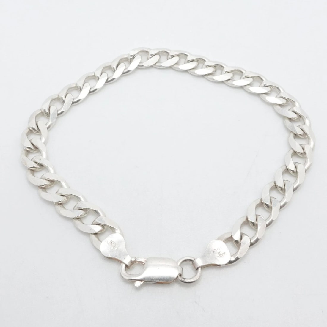 ITALY STERLING SILVER 7MM CUBAN CHAIN LINK BRACELET 8" LONG: ITALY STERLING SILVER 7MM CUBAN CHAIN LINK BRACELET 8" LONG Italy Sterling Silver Cuban Chain Link Bracelet Length - 8" Long Wrist Size - Relax 7.5" - 7.75" Snug Chain Width - 7mm Depth - 2mm Thick To