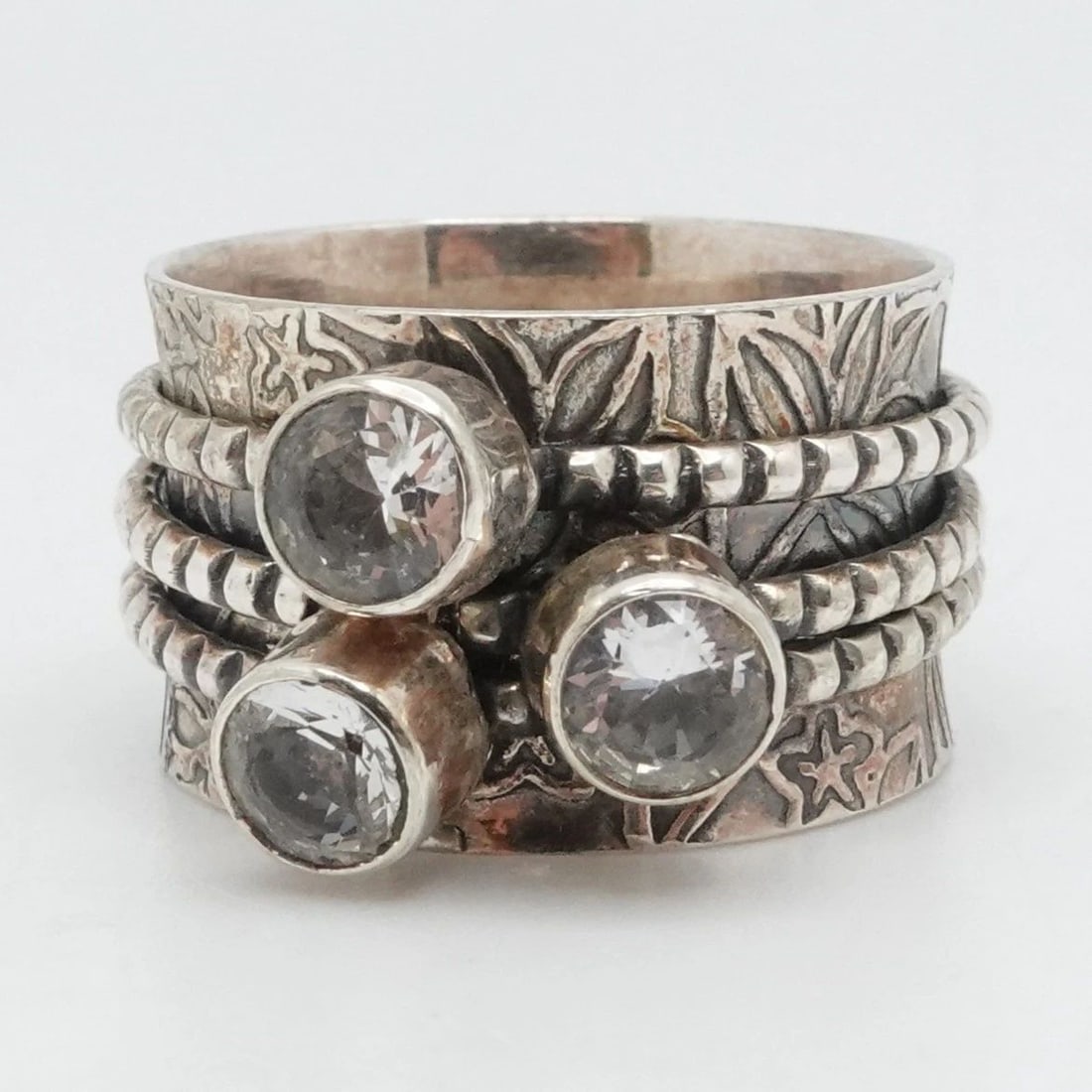 STERLING SILVER ROUND CLEAR CUBIC ZIRCONIA FLOWER SPINNER WIDE BAND RING 10.25: STERLING SILVER ROUND CLEAR CUBIC ZIRCONIA FLOWER SPINNER WIDE BAND RING 10.25 Sterling Silver Round Clear Cubic Zirconia Flower Spinner Wide Band Ring Size - 10.25 Band Width - 14mm CZ Stone Size - 5