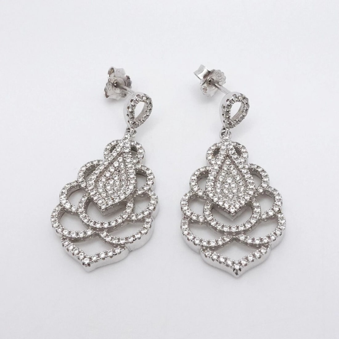 STERLING SILVER PAVE CLEAR CZ CUBIC ZIRCONIA DANGLE EARRINGS 1.5": STERLING SILVER PAVE CLEAR CZ CUBIC ZIRCONIA DANGLE EARRINGS 1.5" Sterling Silver Pave Clear Cubic Zirconia Dangle Earrings Height - 1.5" Width - 0.60" Total Weight - 7.4 Grams