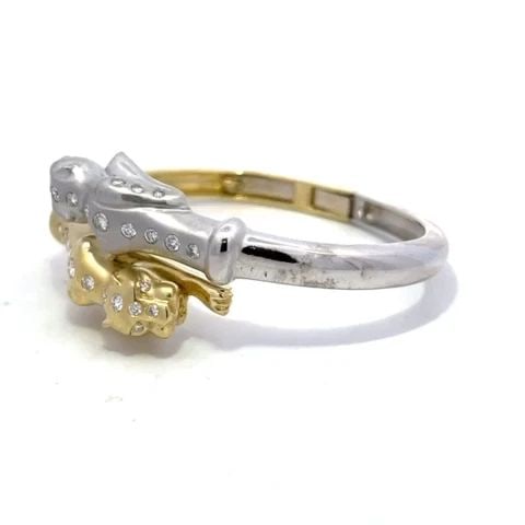 DIAMOND PANTHER BYPASS BRACELET 18K TWO TONE GOLD FLEX HINGED BAND: DIAMOND PANTHER BYPASS BRACELET 18K TWO TONE GOLD FLEX HINGED BAND This is a gorgeous double panther bracelet, it is crafted from 18k yellow and white gold featuring a satin finish white gold panther 