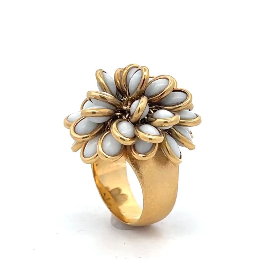 DESIGNER C. AMORIM 18K YELLOW GOLD MOVABLE PETALS FLORAL RING: DESIGNER C. AMORIM 18K YELLOW GOLD MOVABLE PETALS FLORAL RING This beautiful movable ring crafted from 18k yellow gold with a satin finish on a wide dome shape tapered band. On the top of the shank is