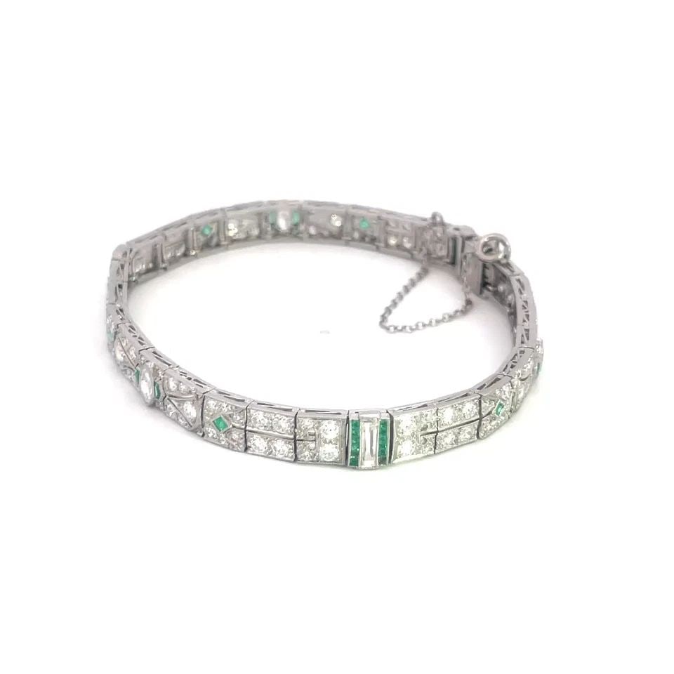 ART DECO DIAMOND PLATINUM EMERALD BRACELET FILIGREE MILGRAIN GEMSTONE: ART DECO DIAMOND PLATINUM EMERALD BRACELET FILIGREE MILGRAIN GEMSTONE This Art Deco diamond platinum bracelet features a floral design with intricate filigree and milgrain details. The entire length b