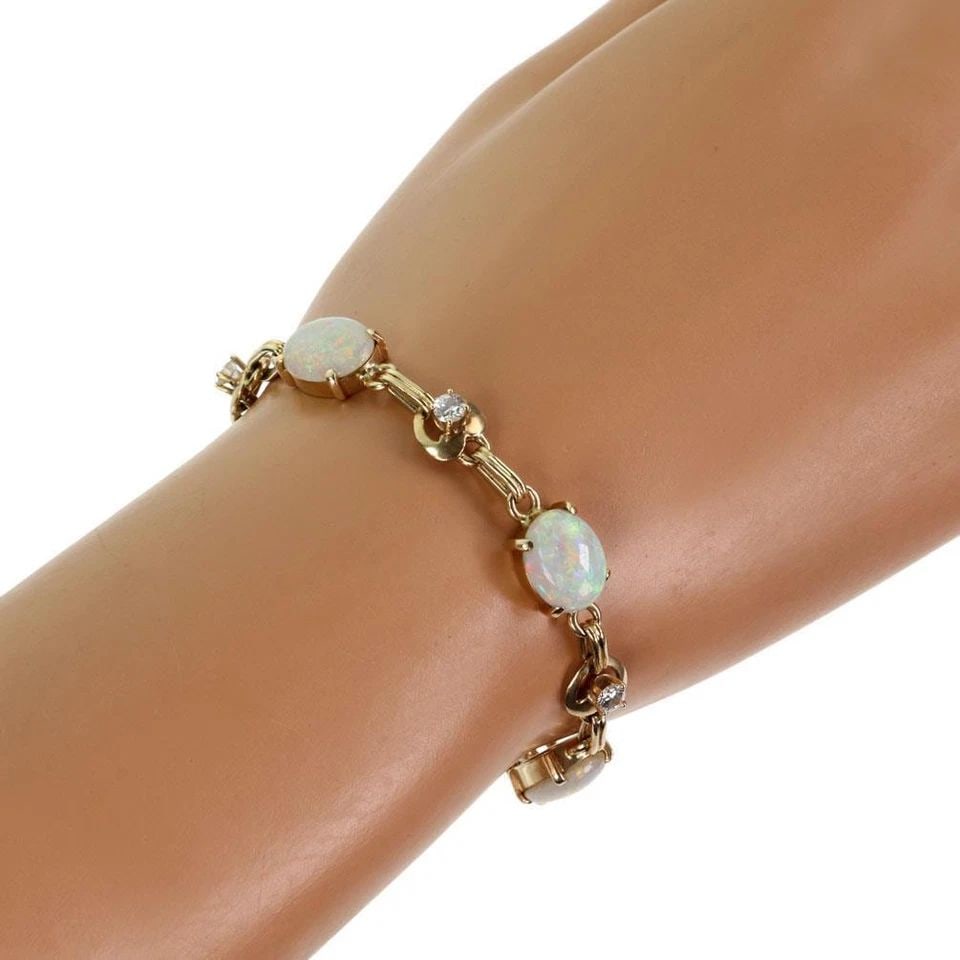 14K YELLOW GOLD 10.40CT FIRE OPAL & DIAMOND FANCY BRACELET: 14K YELLOW GOLD 10.40CT FIRE OPAL & DIAMOND FANCY BRACELET 14k Yellow Gold 10.40ct Fire Opal & Diamond Fancy Bracelet Description This beautiful bracelet is crafted from 14k yellow gold feauring 5 ova