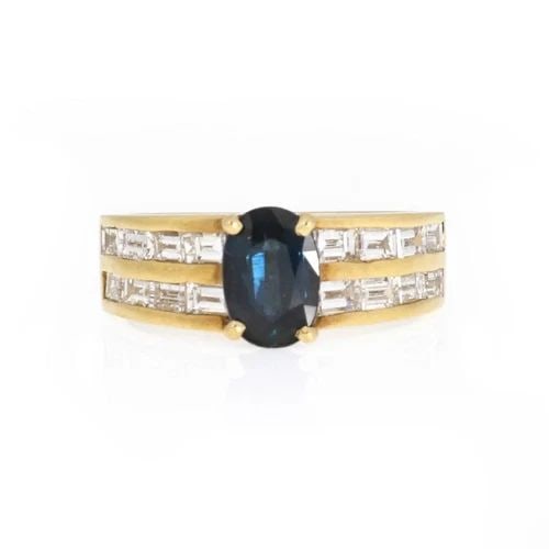 18K YELLOW GOLD DIAMOND & SAPPHIRE CHANNEL RING: 18K YELLOW GOLD DIAMOND & SAPPHIRE CHANNEL RING 18k Yellow Gold Diamond & Sapphire Channel Ring Description This elegant cocktail ring is crafted from 18k yellow gold featuring an oval shape sapphire 