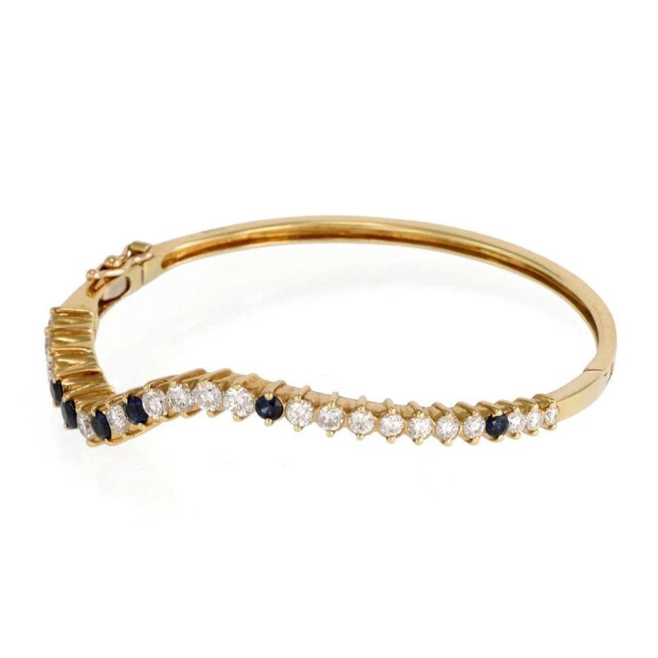 LOVELY 3.46CT DIAMOND & SAPPHIRE 18K YELLOW GOLD WAVE BANGLE: LOVELY 3.46CT DIAMOND & SAPPHIRE 18K YELLOW GOLD WAVE BANGLE Lovely 3.46ct Diamond & Sapphire 18k Yellow Gold Wave Bangle Description This is a gorgeous wave style bangle, it is crafted from 18k yello