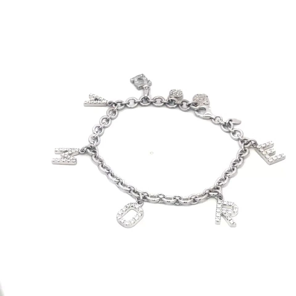 DODO GOLD DIAMOND BRACELET BY POMELLATO 18K WHITE AMORE CHARMS DANGLE STYLE: The romantic piece is from Dodo by Pomellato, it is a luxurious piece of fine jewelry crafted from in white gold featuring a charming dangle style with 5 letter spelled AMORE and 3 charms all with pav