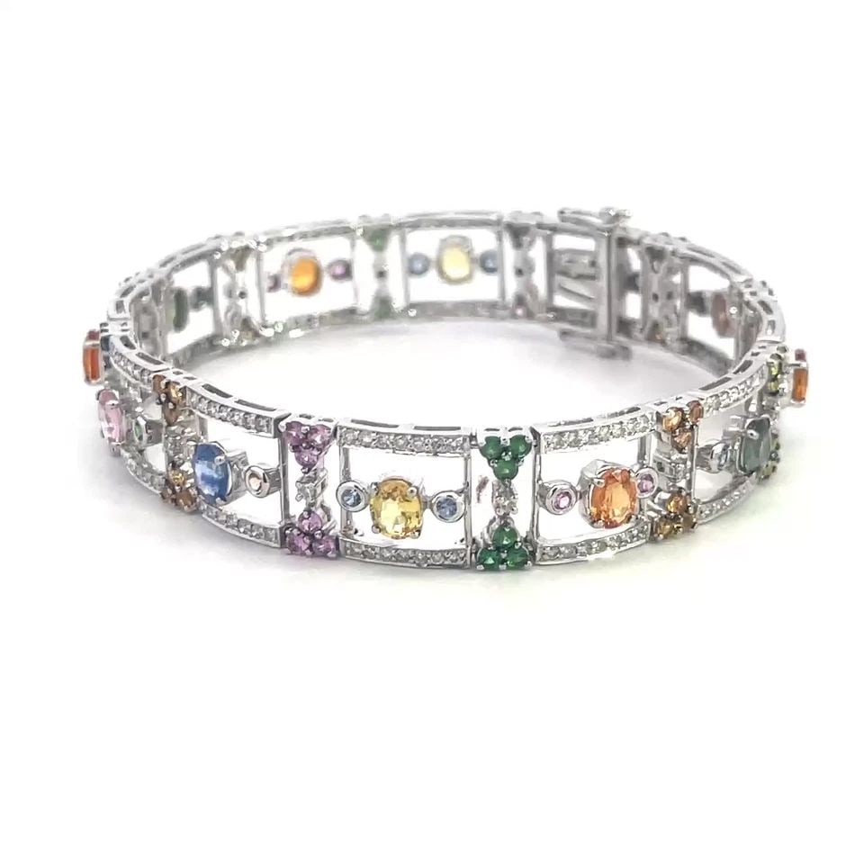 SAPPHIRE DIAMOND GOLD BRACELET 1CT 18K WHITE MULTICOLOR OPEN WIDE LINKS: SAPPHIRE DIAMOND GOLD BRACELET 1CT 18K WHITE MULTICOLOR OPEN WIDE LINKS This beautiful bracelet is crafted from 18k white gold featuring open style square links which alternates with small hourglass l