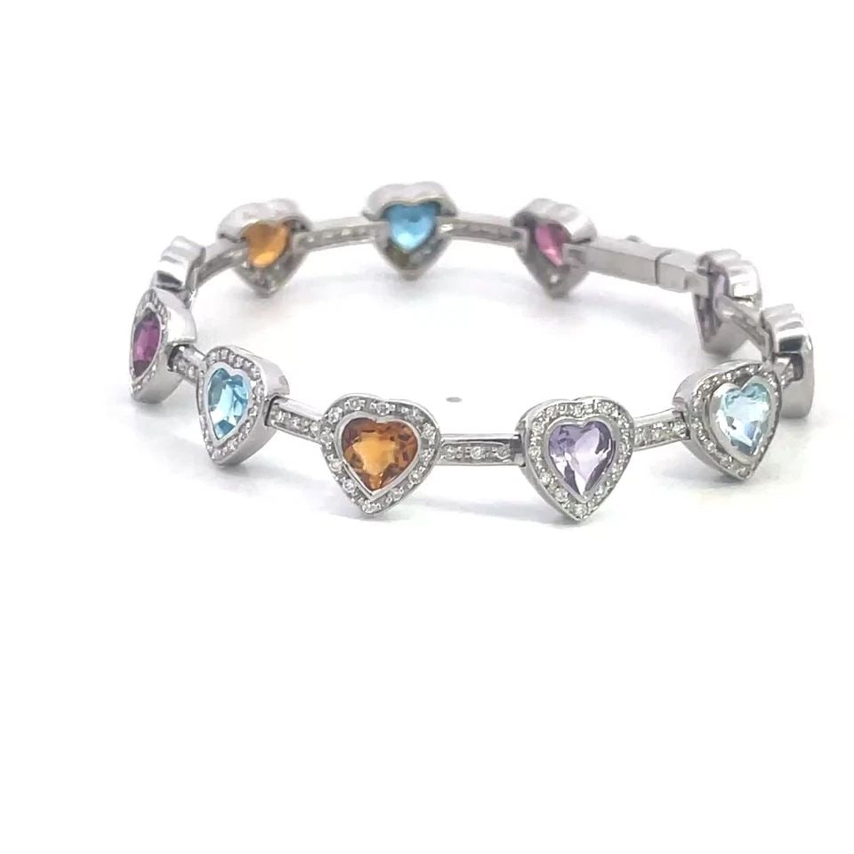 DIAMOND GOLD BRACELET 14K WHITE MULTI-COLOR GEMSTONE HEART LINK STYLE: This lovely hearts and bar link bracelet is crafted from 14k white gold, each heart has a bezel set colored gemstone with diamond bezel and each bar has prong set diamonds. The bracelet secures with a