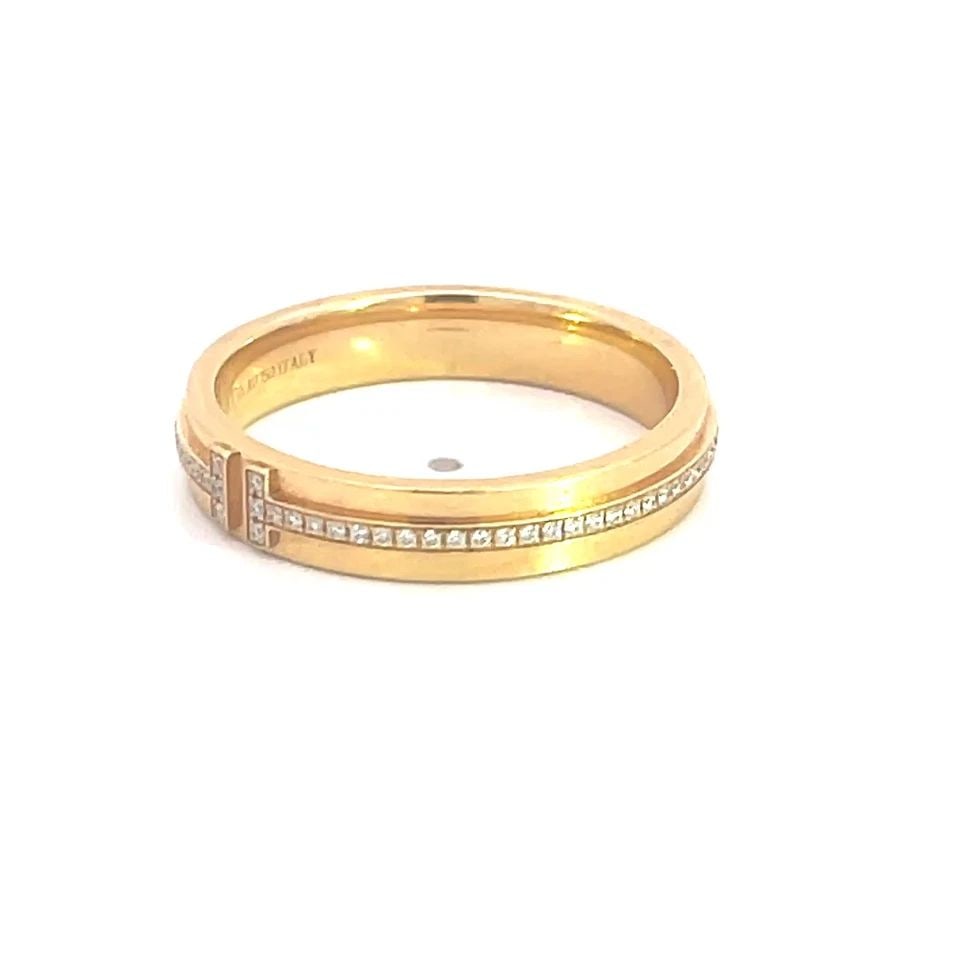 TIFFANY T NARROW DIAMOND BAND 18K YELLOW GOLD SIZE 10: The Tiffany T Narrow diamond band in 18k yellow gold, size 10, is a luxurious and elegant ring perfect for special occasions such as weddings, anniversaries, and birthdays. The natural white round dia