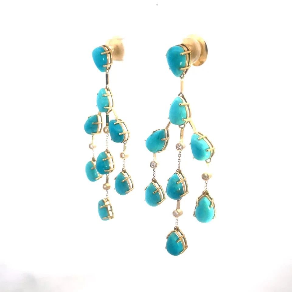 TURQUOISE GOLD CHANDELIER EARRINGS DIAMOND 18K YELLOW DANGLE STYLE: TURQUOISE GOLD CHANDELIER EARRINGS DIAMOND 18K YELLOW DANGLE STYLE The product is a pair of vintage 18k yellow gold chandelier earrings featuring prong set pear shape turquoise gemstones in a dangling