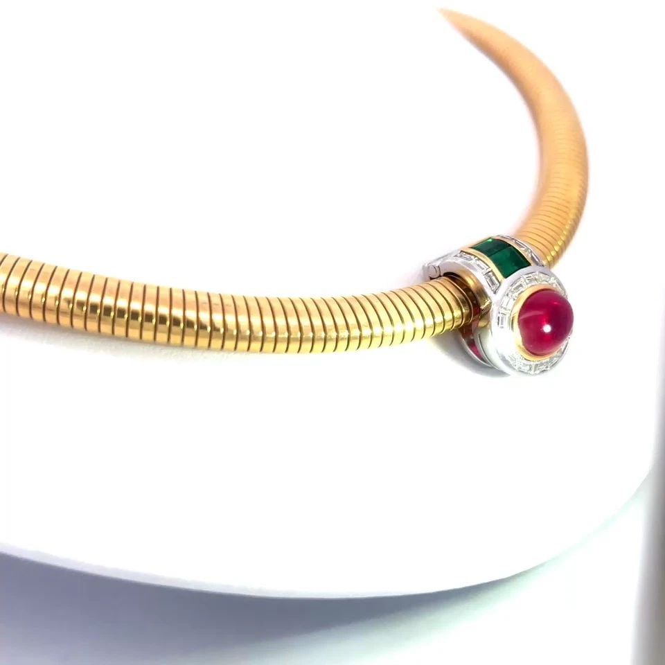 RUBY EMERALD GOLD NECKLACE DIAMOND ENHANCER 18K YELLOW SLIDE OMEGA COLLAR: RUBY EMERALD GOLD NECKLACE DIAMOND ENHANCER 18K YELLOW SLIDE OMEGA COLLAR This is a stunning piece of fine jewelry, the 8mm wide omega necklace is 18k yellow gold with a polished finish and comes with