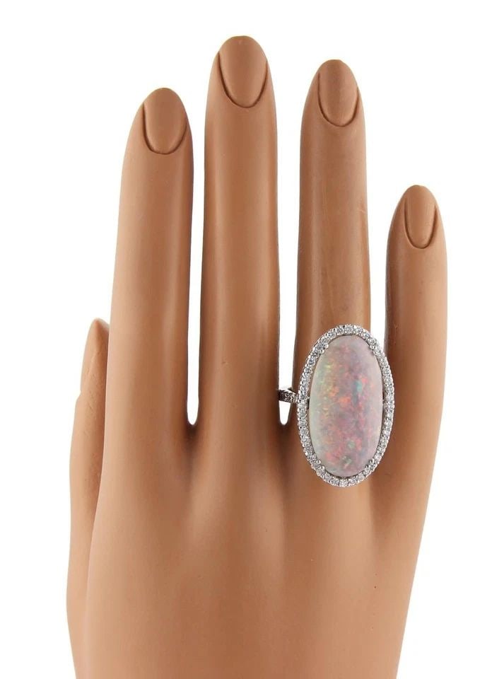 DIAMOND OPAL GOLD RING 18KT WHITE LARGE OVAL HALO TOP ESTATE: DIAMOND OPAL GOLD RING 18KT WHITE LARGE OVAL HALO TOP ESTATE DIAMOND OPAL GOLD RING 18KT WHITE LARGE OVAL HALO TOP ESTATE This Diamond and Opal Gold Ring in 18kt White Estate is a stunning piece of fi