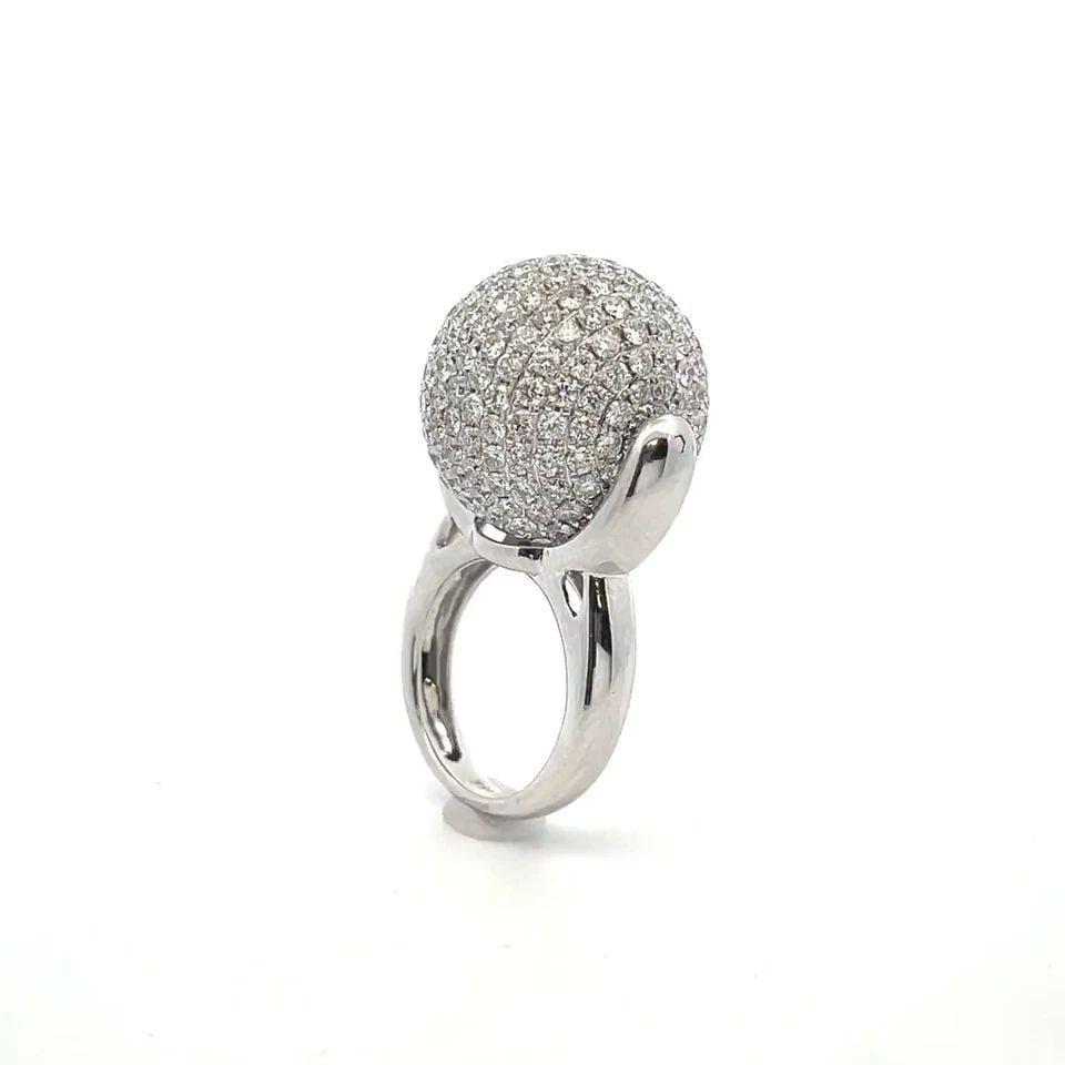 DIAMOND RING 20MM SPINNER BALL 18K WHITE GOLD RING SIZE 6.25: DIAMOND RING 20MM SPINNER BALL 18K WHITE GOLD RING SIZE 6.25 The product is an 18k white gold ring with a unique 20 mm spinner ball design featuring round cut diamonds . The ring is size 6.25 and has 