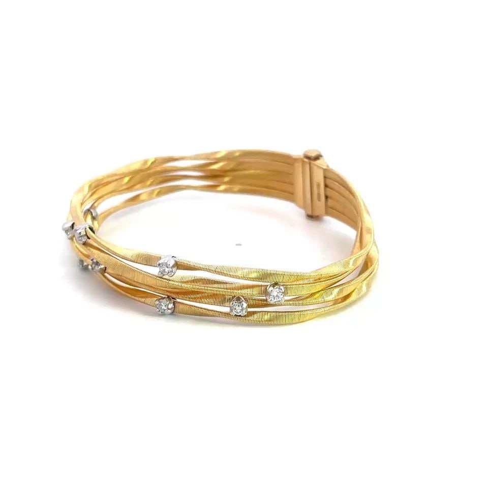 MARCO BICEGO MARRAKESH GOLD BRACELET DIAMOND 18K MOTIF 5 STRAND WAVE BAND: MARCO BICEGO MARRAKESH GOLD BRACELET DIAMOND 18K MOTIF 5 STRAND WAVE BAND The Marco Bicego Marrakesh 18k yellow gold bracelet is a stunning piece of fine jewelry that features 5 unique cable style wav