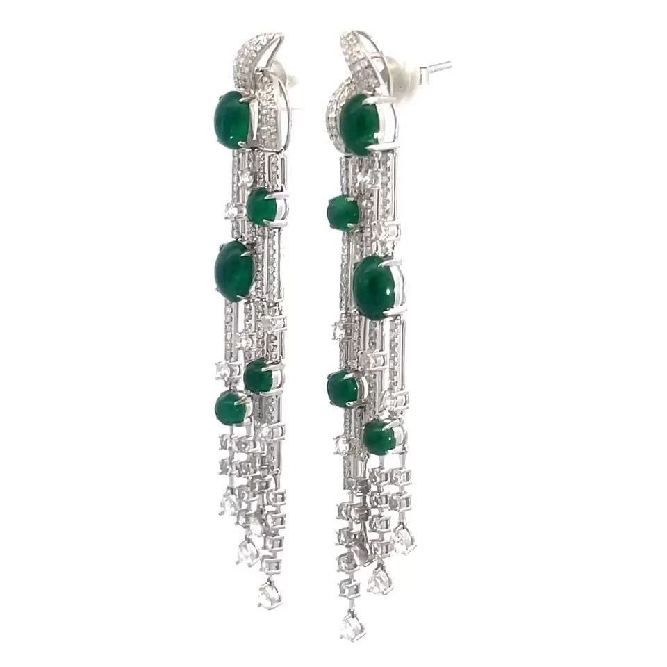 EMERALD DIAMOND GOLD EARRINGS 18K WHITE 6.5CT 4 STRAND DANGLE STYLE: EMERALD DIAMOND GOLD EARRINGS 18K WHITE 6.5CT 4 STRAND DANGLE STYLE This pair of luxurious earrings are crafted from 18k white gold featuring 4 slim long strands in a set of two with oval cabochon eme