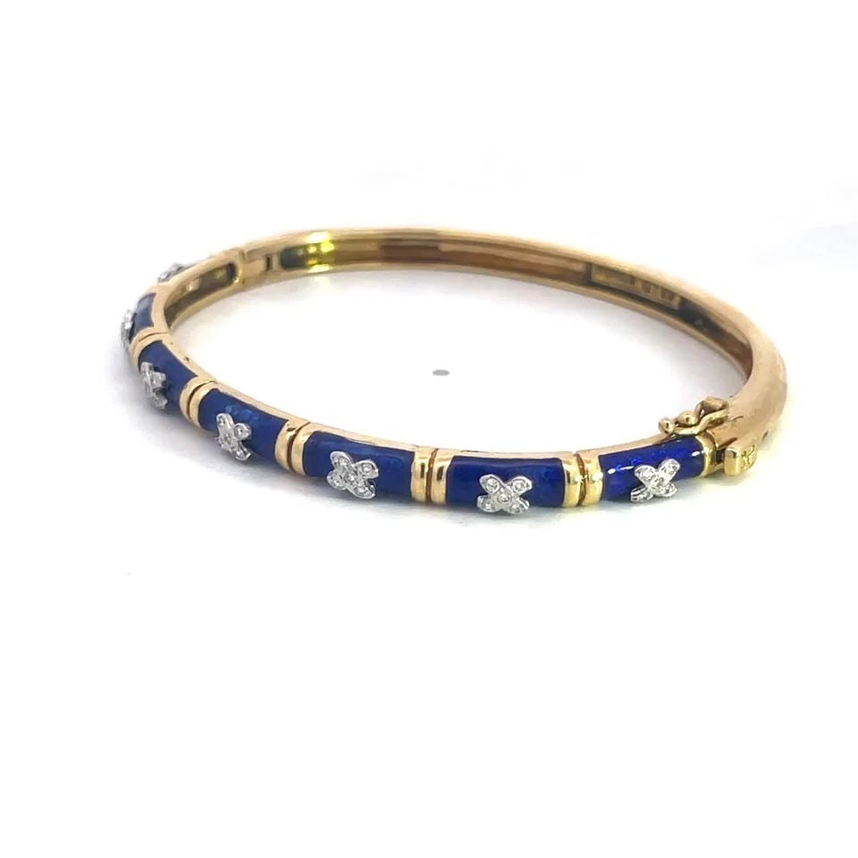 DIAMOND BLUE ENAMEL GOLD BANGLE 18K TWO TONE X STYLE OVAL SHAPE: DIAMOND BLUE ENAMEL GOLD BANGLE 18K TWO TONE X STYLE OVAL SHAPE DIAMOND BLUE ENAMEL GOLD BANGLE 18K TWO TONE X STYLE OVAL SHAPE Elevate your accessory collection with this lovely diamond enamel gold b