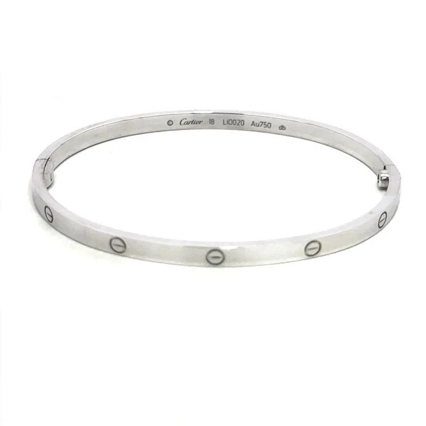 CARTIER LOVE GOLD BANGLE SMALL MODEL 18K WHITE SIZE 18 BOX & CERTIFICATE: CARTIER LOVE GOLD BANGLE SMALL MODEL 18K WHITE SIZE 18 BOX & CERTIFICATE CARTIER LOVE GOLD BANGLE SMALL MODEL 18K WHITE SIZE 18 BOX & CERTIFICATE This elegant bangle is by Cartier, from 18k white gold