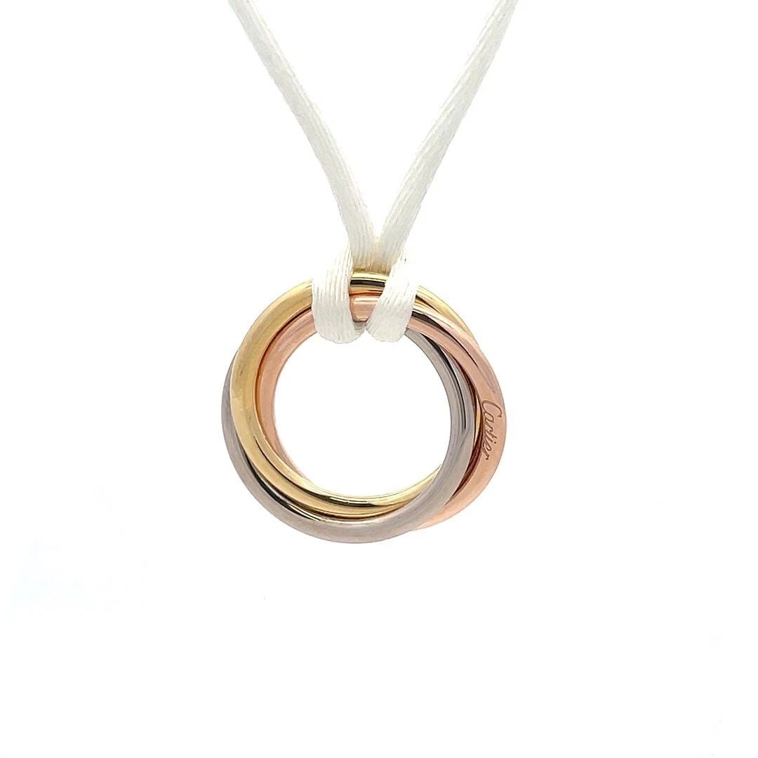 CARTIER TRINITY 18K GOLD PENDANT TRICOLOR GOLD CORD NECKLACE PAPER POUCH: CARTIER TRINITY 18K GOLD PENDANT TRICOLOR GOLD CORD NECKLACE PAPER POUCH CARTIER TRINITY 18K GOLD PENDANT TRICOLOR GOLD CORD NECKLACE PAPER POUCH An authentic chic necklace by Cartier from the Trinity