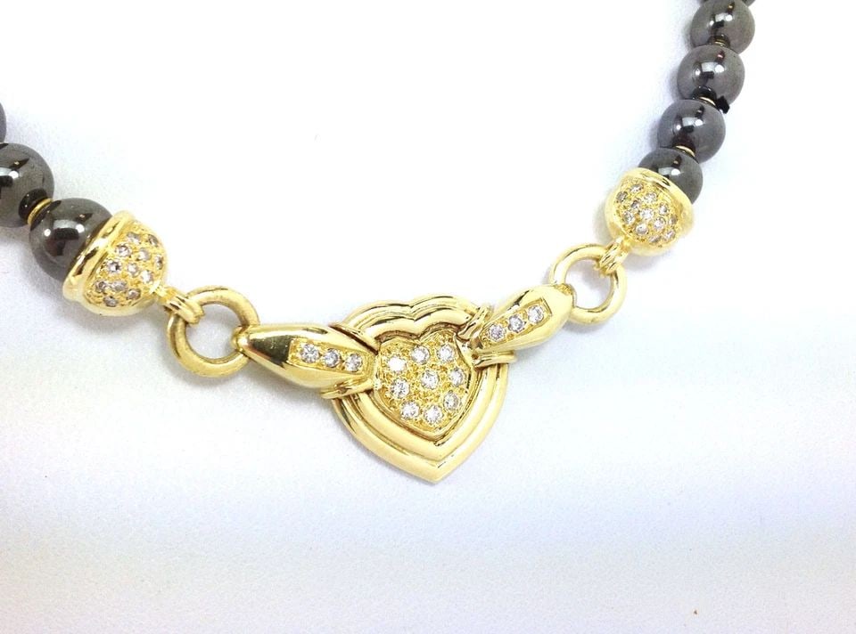 DIAMOND HEMATITE GOLD NECKLACE 18K YELLOW BEAD CHAIN HEART MOTIF: DIAMOND HEMATITE GOLD NECKLACE 18K YELLOW BEAD CHAIN HEART MOTIF DIAMOND HEMATITE GOLD NECKLACE 18K YELLOW BEAD CHAIN HEART MOTIF This Diamond Hematite Gold Necklace features a heart-shaped pendant wi