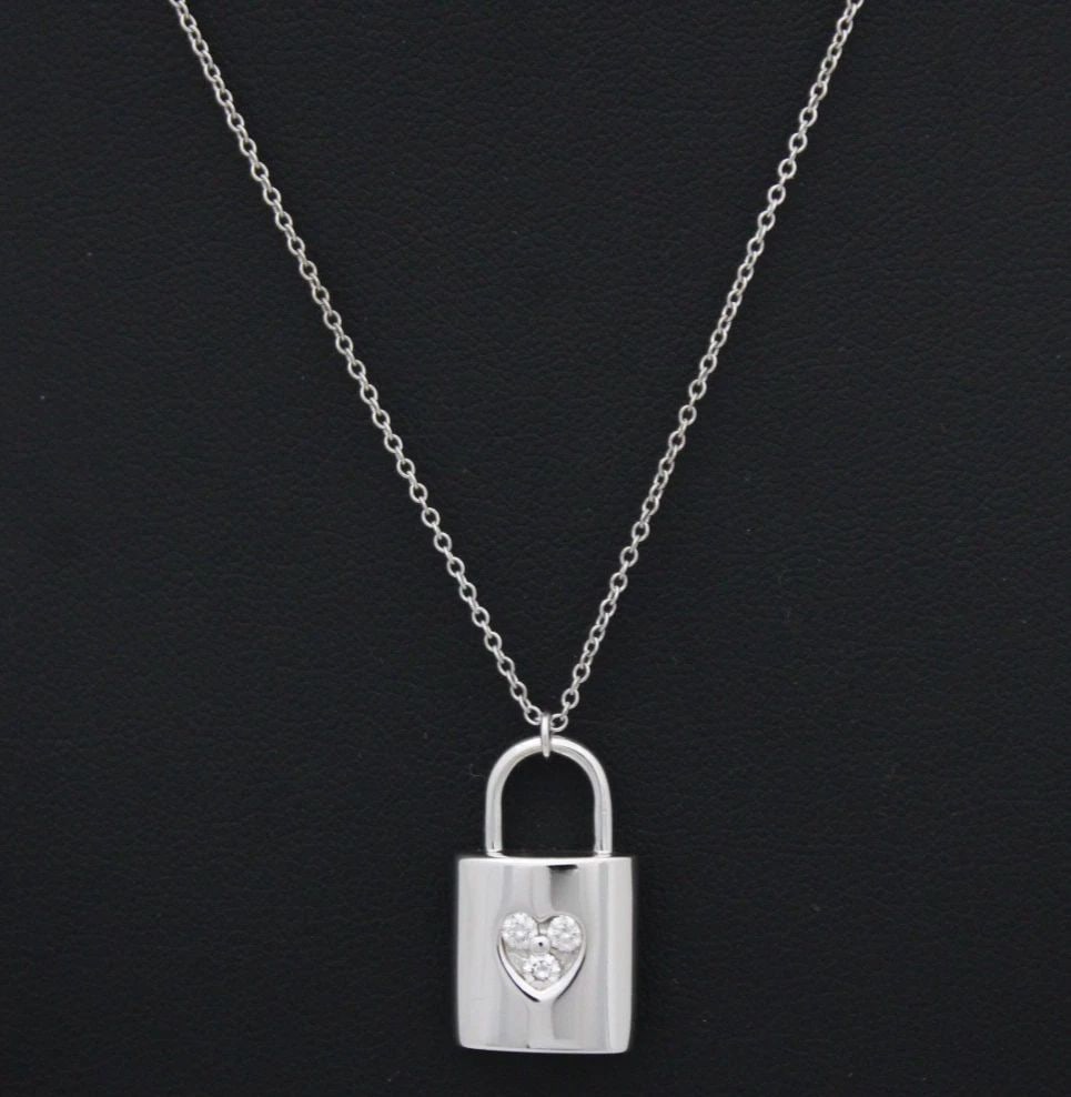 TIFFANY & CO. DIAMOND 18K WHITE GOLD PADLOCK PENDANT & CHAIN NECKLACE 16": TIFFANY & CO. DIAMOND 18K WHITE GOLD PADLOCK PENDANT & CHAIN NECKLACE 16" Description Tiffany & Co. Diamond 18k White Gold Padlock Pendant & Chain Necklace 16" Necklace/pendant is in good condition. M