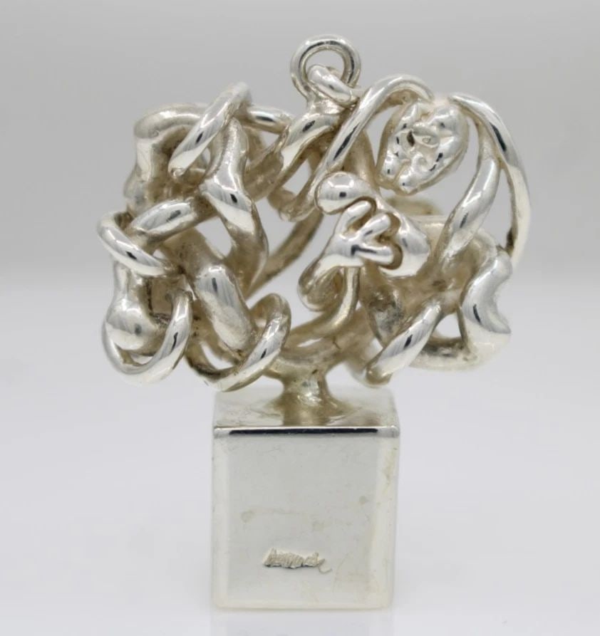 MIGUEL BERRROCAL STERLING SILVER MICROMENTO PUZZLE SCULPTURE PENDANT W/ BROCHURE: MIGUEL BERRROCAL STERLING SILVER MICROMENTO PUZZLE SCULPTURE PENDANT W/ BROCHURE Description Miguel Berrrocal Sterling Silver Micromento Puzzle Sculpture Pendant w/ Brochure *Pendant has been repaired