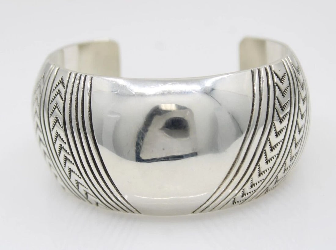 ORVILLE TSINNIE NAVAJO STERLING SILVER NEW MEXICO HAND STAMPED CUFF BRACELET: ORVILLE TSINNIE NAVAJO STERLING SILVER NEW MEXICO HAND STAMPED CUFF BRACELET Description Orville Tsinnie NAVAJO Sterling Silver New Mexico Hand Stamped Cuff Bracelet The bracelet is in great condition