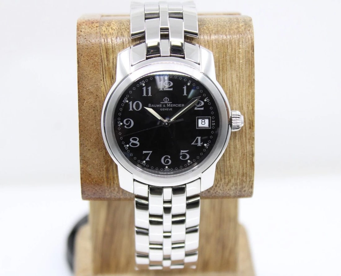BAUME & MERCIER CAPELAND 37MM BLACK DATE DIAL STAINLESS WATCH MV045214: BAUME & MERCIER CAPELAND 37MM BLACK DATE DIAL STAINLESS WATCH MV045214 Description Baume & Mercier Capeland 37mm Black Date Dial Stainless Watch MV045214 The watch has been used previously. The watch 