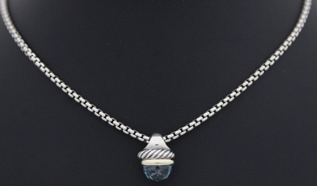 DAVID YURMAN STERLING SILVER W/ 14K GOLD BLUE TOPAZ ACORN PENDANT NECKLACE 16": DAVID YURMAN STERLING SILVER W/ 14K GOLD BLUE TOPAZ ACORN PENDANT NECKLACE 16" Description David Yurman Sterling Silver w/ 14K Gold Blue Topaz Acorn Pendant Necklace Necklace is in good condition. May