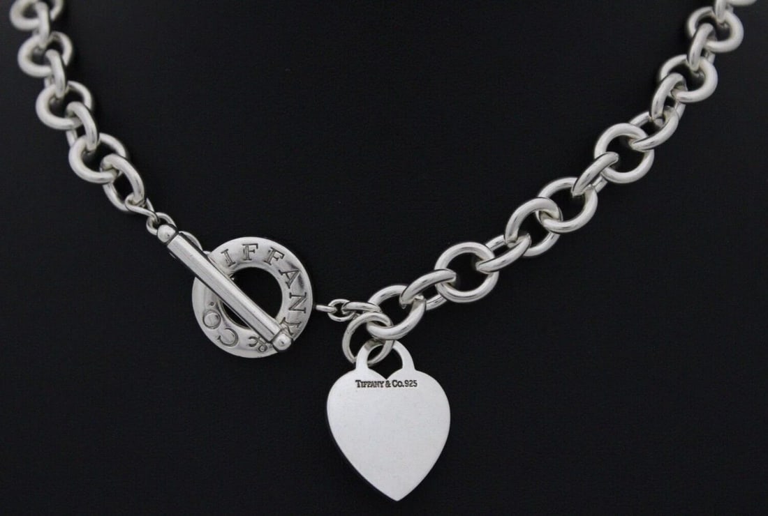 TIFFANY & CO. STERLING BLANK (ENGRAVED T.L.W) HEART TAG 16" TOGGLE NECKLACE: TIFFANY & CO. STERLING BLANK (ENGRAVED T.L.W) HEART TAG 16" TOGGLE NECKLACE TIFFANY & CO. STERLING BLANK (ENGRAVED T.L.W) HEART TAG 16" TOGGLE NECKLACE Description Tiffany & Co. Sterling Silver Blank 