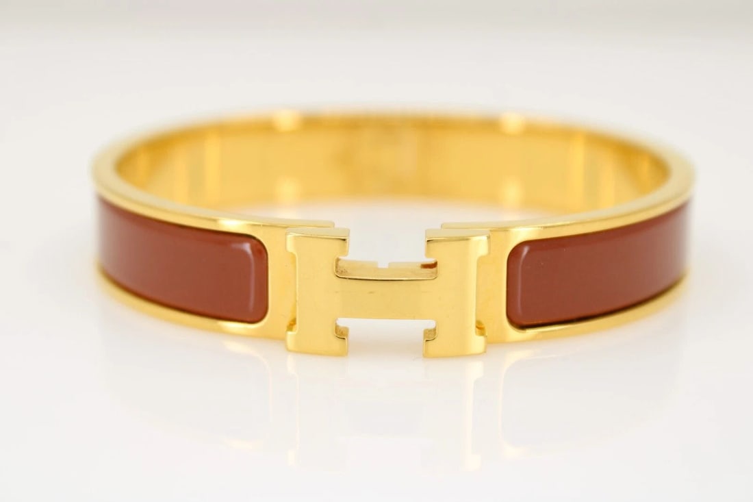 HERMES GOLD TONE PAPAYA ENAMEL CLIC CLAC H NARROW BRACELET SIZE 6 3/4": HERMES GOLD TONE PAPAYA ENAMEL CLIC CLAC H NARROW BRACELET SIZE 6 3/4" HERMES GOLD TONE PAPAYA ENAMEL CLIC CLAC H NARROW BRACELET SIZE 6 3/4" Description Hermes Gold Tone Papaya Enamel Clic Clac H Nar