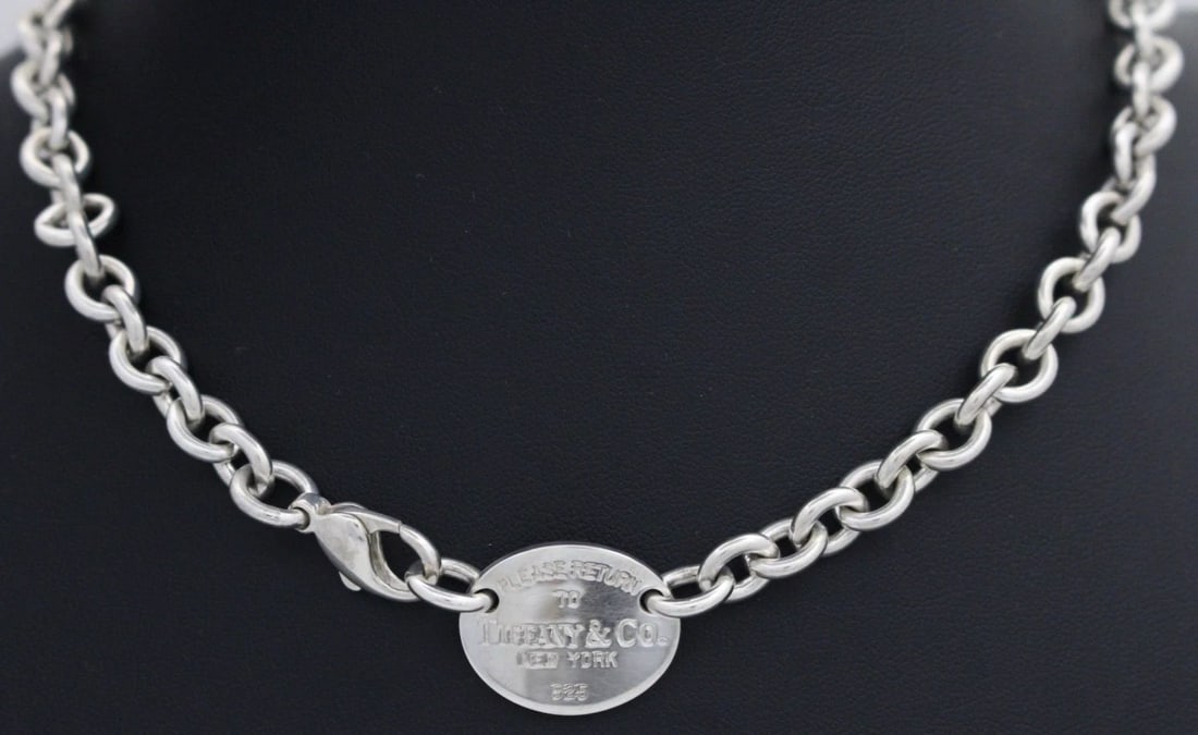 TIFFANY & CO. STERLING SILVER "RETURN TO TIFFANY" OVAL TAG NECKLACE 16" W/ POUCH: TIFFANY & CO. STERLING SILVER "RETURN TO TIFFANY" OVAL TAG NECKLACE 16" W/ POUCH Description Tiffany & Co. Sterling Silver "Return to Tiffany" Oval Tag Necklace Necklace is in good condition. May show
