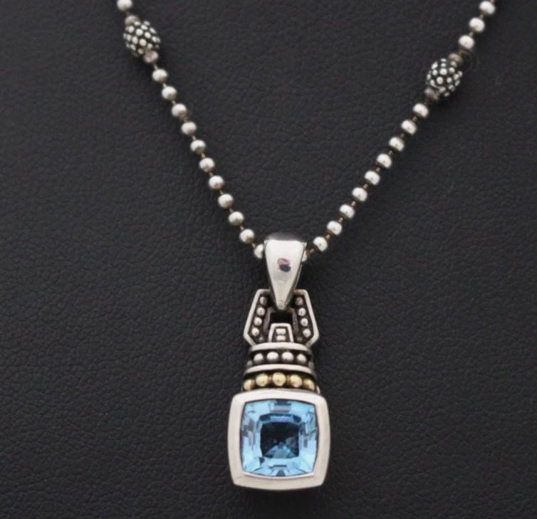 LAGOS STERLING SILVER & 18K YELLOW GOLD BLUE TOPAZ PENDANT W/ 18" NECKLACE: LAGOS STERLING SILVER & 18K YELLOW GOLD BLUE TOPAZ PENDANT W/ 18" NECKLACE Description Lagos Sterling Silver & 18K Yellow Gold Blue Topaz Pendant w/ 18" Necklace Pendant/necklace is in good condition.