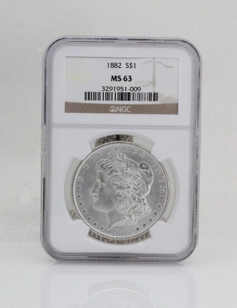 1882 $1 MORGAN SILVER DOLLAR NGC MS 63: 1882 $1 MORGAN SILVER DOLLAR NGC MS 63 1882 $1 MORGAN SILVER DOLLAR NGC MS 63 Description 1882 $1 Morgan Silver Dollar NGC MS 63 Coin is in great condition. Plastic case may show signs of wear and/or 