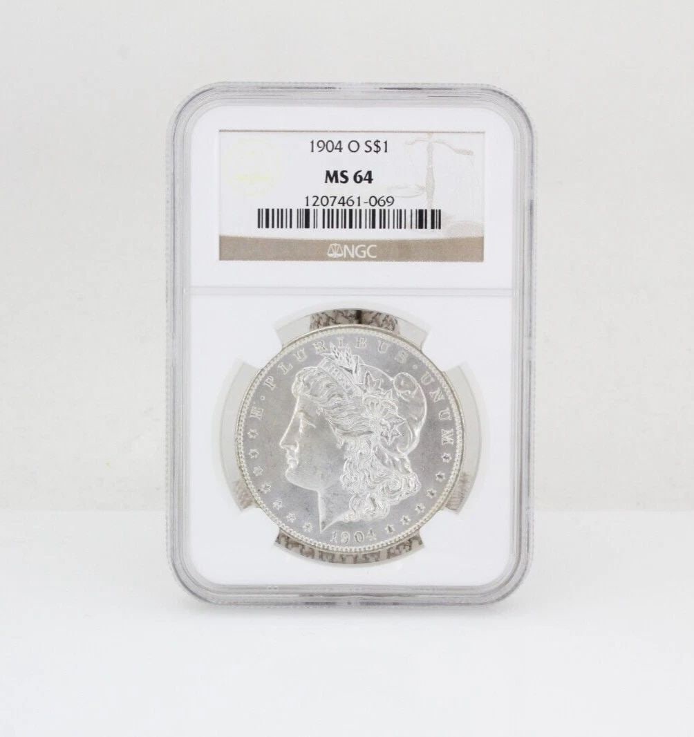 1904 O S$1 MORGAN SILVER DOLLAR NGC MS 64: 1904 O S$1 MORGAN SILVER DOLLAR NGC MS 64 1904 O S$1 MORGAN SILVER DOLLAR NGC MS 64 Description 1904 O S$1 Morgan Silver Dollar NGC MS 64 Coin is in great condition. Plastic holder may show signs of w