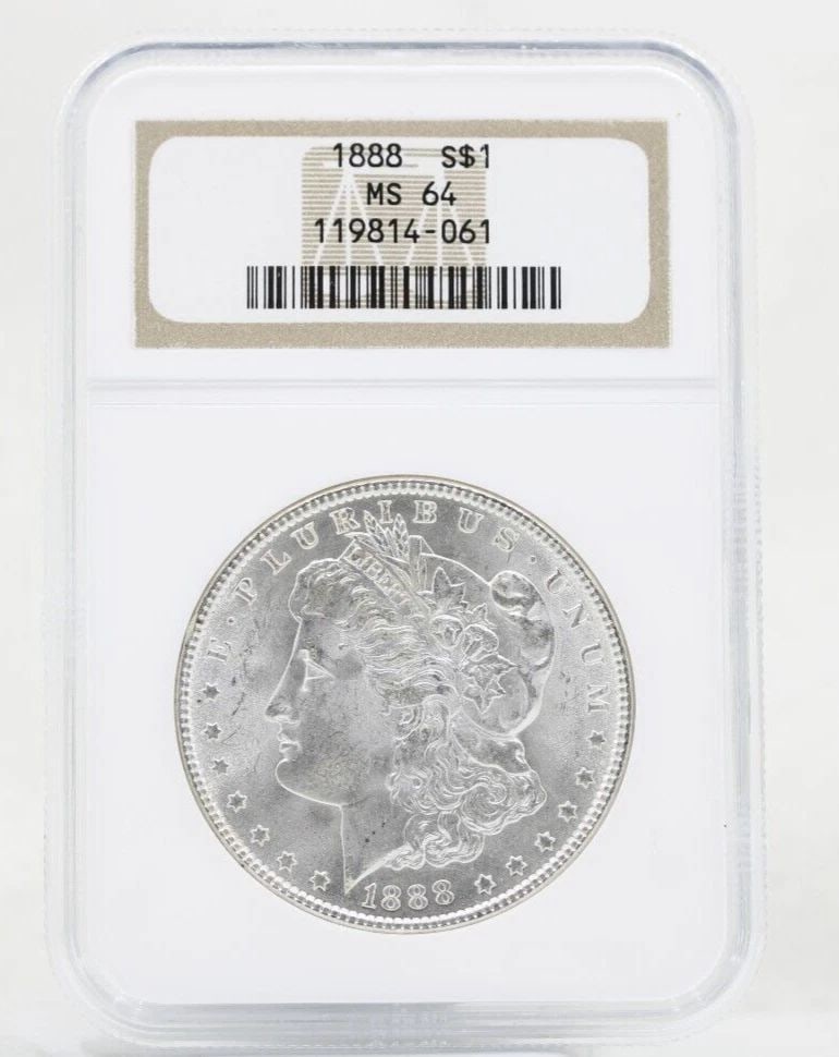1888 P MORGAN SILVER DOLLAR NGC MS-64 OLD NGC HOLDER: 1888 P MORGAN SILVER DOLLAR NGC MS-64 OLD NGC HOLDER Description 1888 P Morgan Silver Dollar NGC MS-64 Old NGC Holder Coins has been graded as a MS-64 by NGC. The protective plastic holder may show si